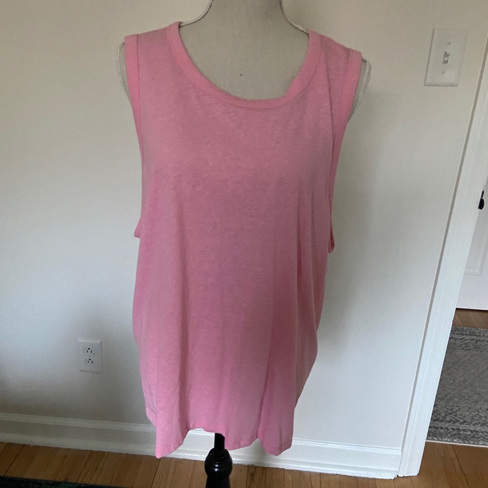Runs small. Nice sleeveless top, ties in back or can be left open.